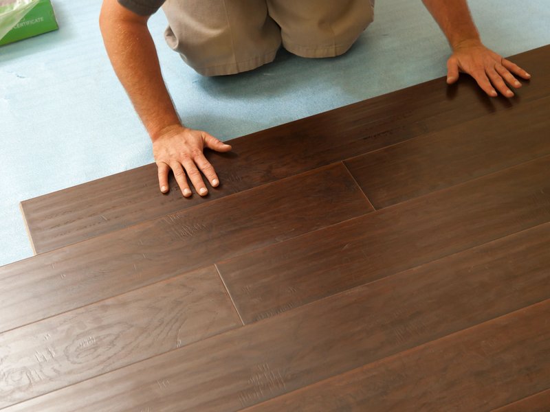 flooring installer installing hardwood flooring